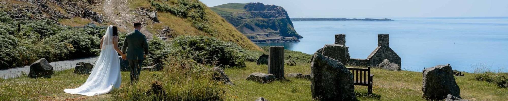 Bride and groom walking down to the private beach below Nant Gwrtheyrn