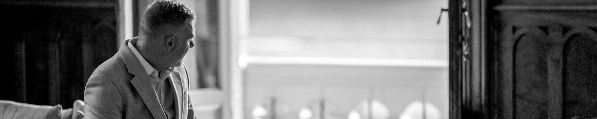 Wedding guest relaxing on the terrace with panoramic coastal views of Eryri from Chateau Rhianfa