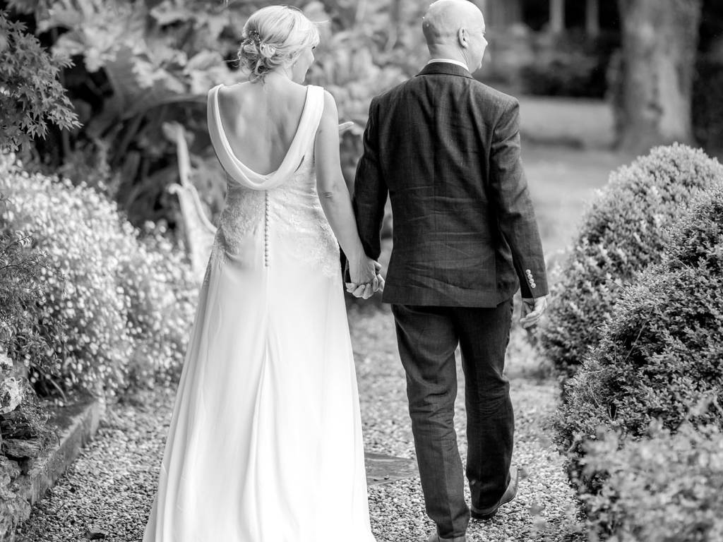 Couple walking in the stunning gardens of Chateau Rhianfa overlooking the Menai Straits and Eryri